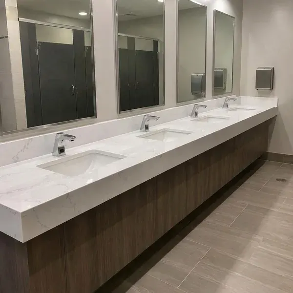 Commercial restroom vanity countertop with multiple sinks set at accessible height in Baltimore