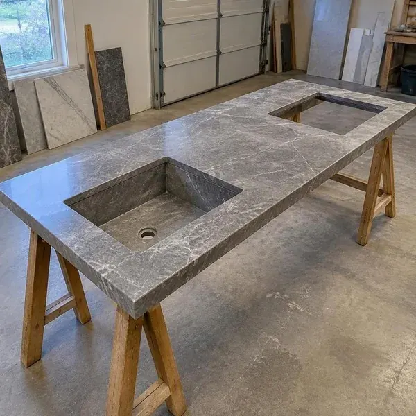 Fabricated stone countertop pieces with sink cutouts in a shop, where dust control during cutting matters most