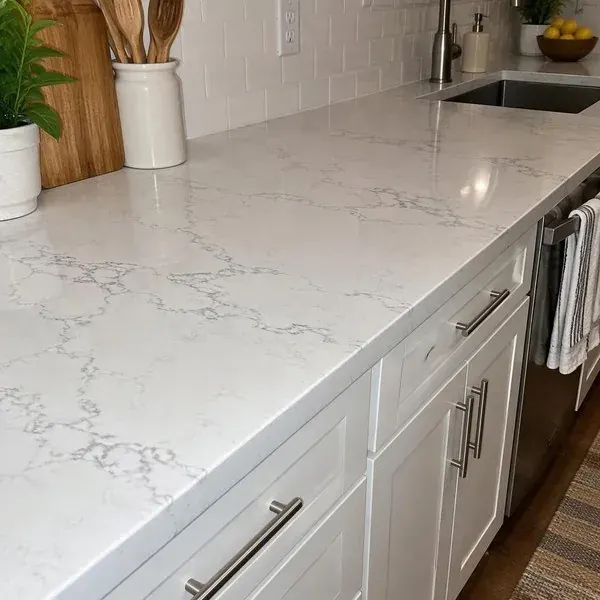 Gray-veined quartz countertop on white kitchen cabinets, the engineered stone behind recent silica safety questions