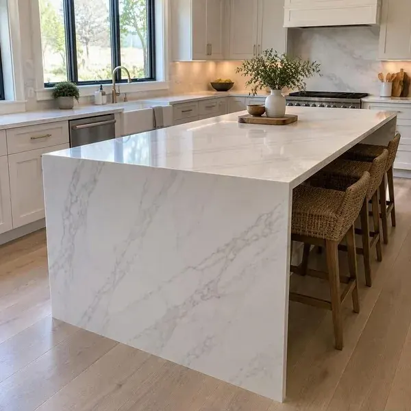 White marble waterfall edge island with continuous veining down the side panel in a bright Baltimore kitchen