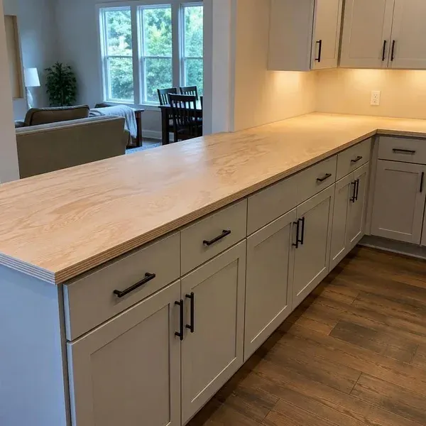 Plywood countertop template on cabinets Plywood strip countertop template laid across kitchen cabinets to capture exact wall lines before fabrication