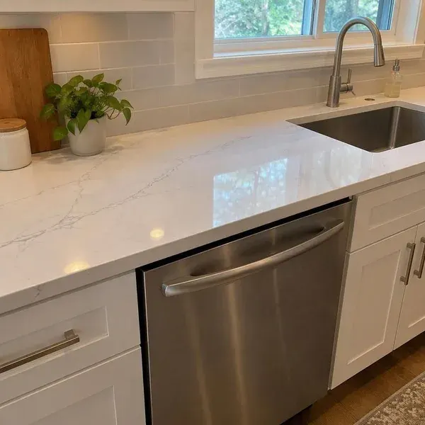 Quartz countertop run above a dishwasher, a common spot for edge chips needing quartz repair in Baltimore