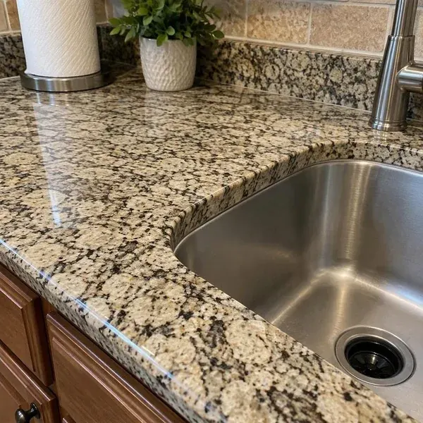 Granite sink rail beside an undermount cutout, the narrow strip where most granite countertop cracks begin