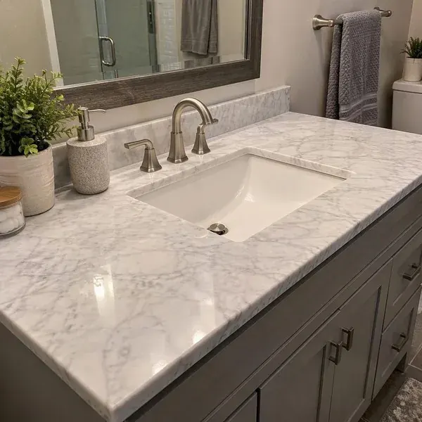 Sealed white marble bathroom vanity top restored to an even polished finish